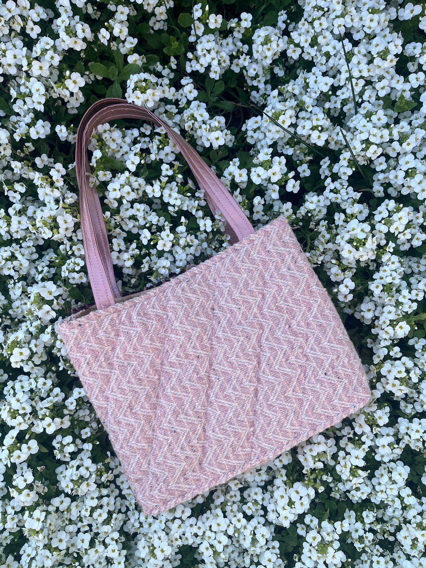 The Gosforth large tweed handbag, featuring structured satin handles and sleek metallic accents.