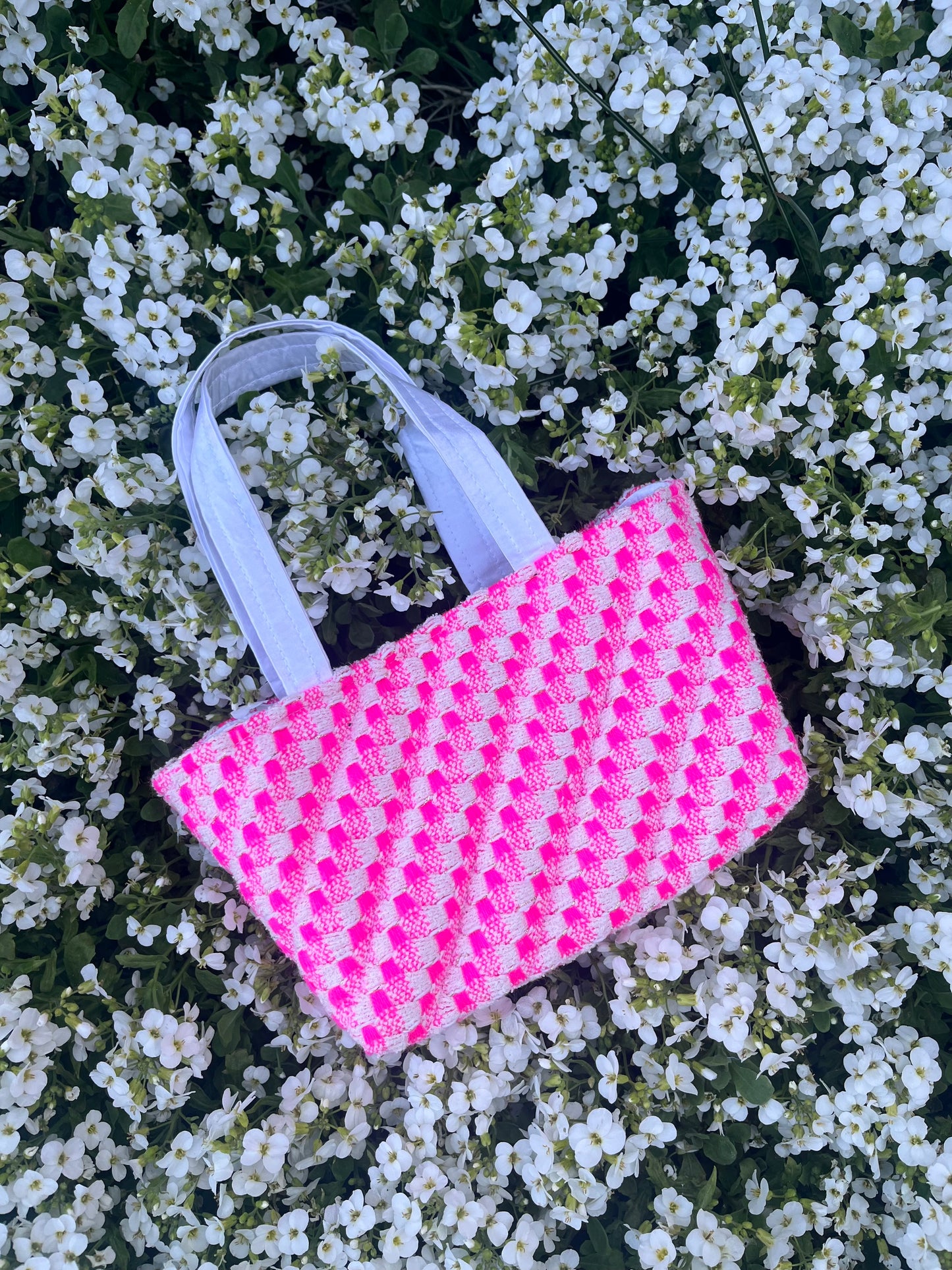 The Warkworth mini handbag crafted from rich tweed, featuring structured satin handles and statement metal hardware for a bold, sophisticated look.