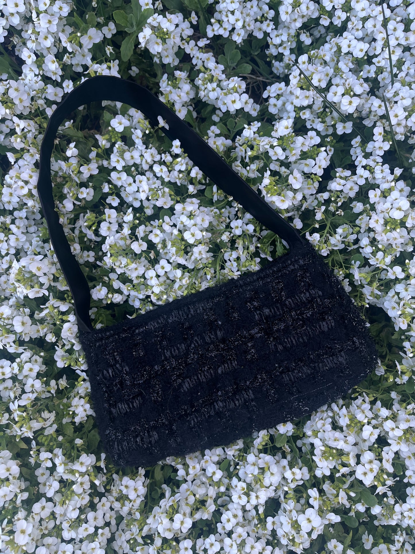 The Cresswell baguette handbag in premium tweed, styled with structured satin handles and polished metal hardware for a chic, compact statement.