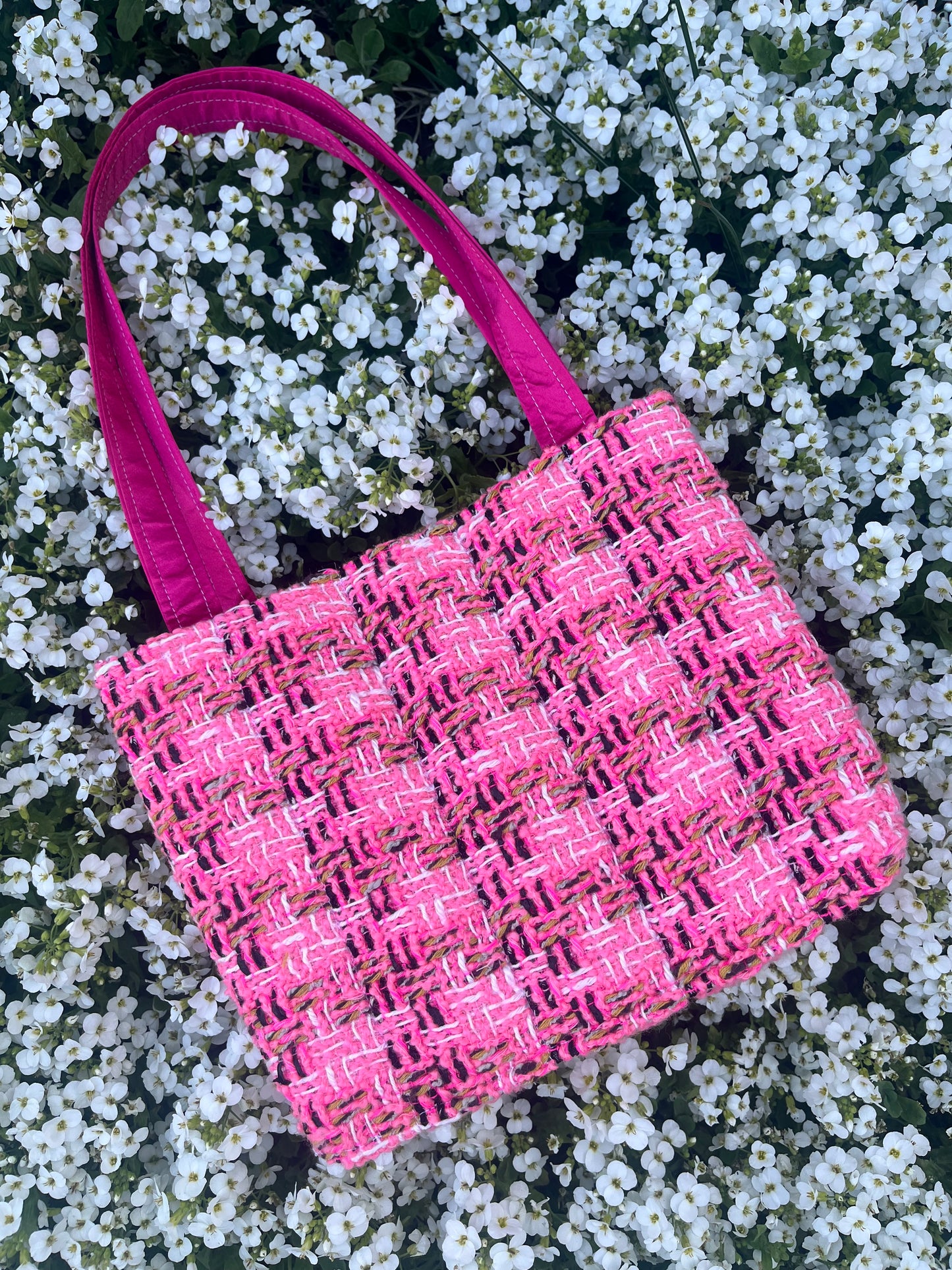 The Alnwick large handbag crafted from sustainable tweed, featuring structured satin handles with polished metal hardware.