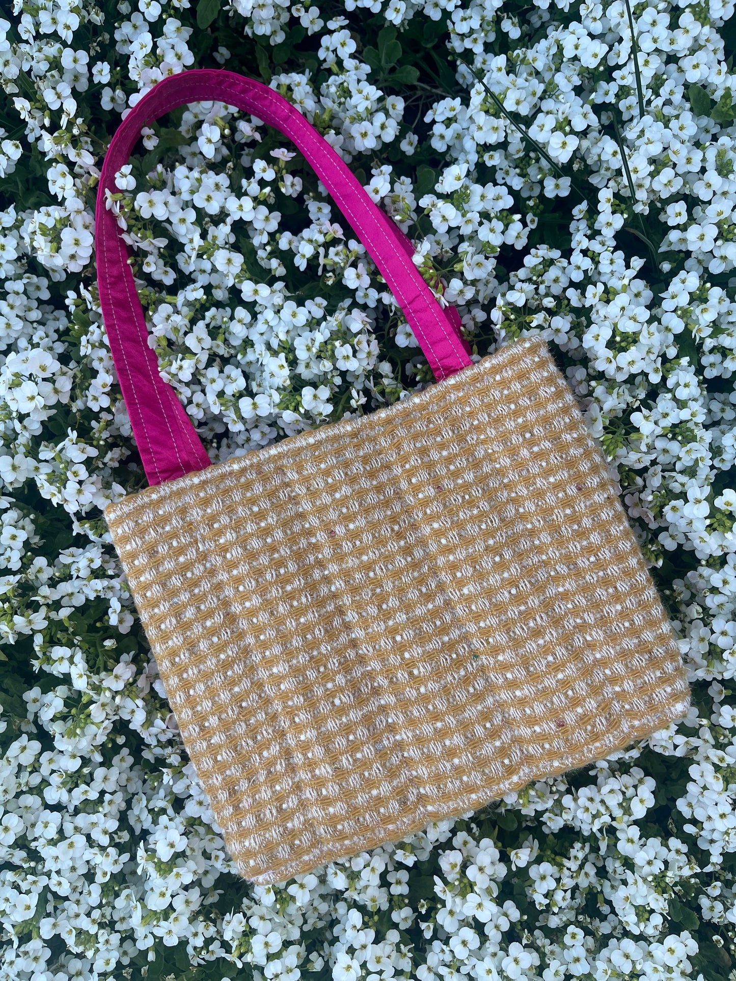 The Alnwick large handbag crafted from sustainable tweed, featuring structured satin handles with polished metal hardware.