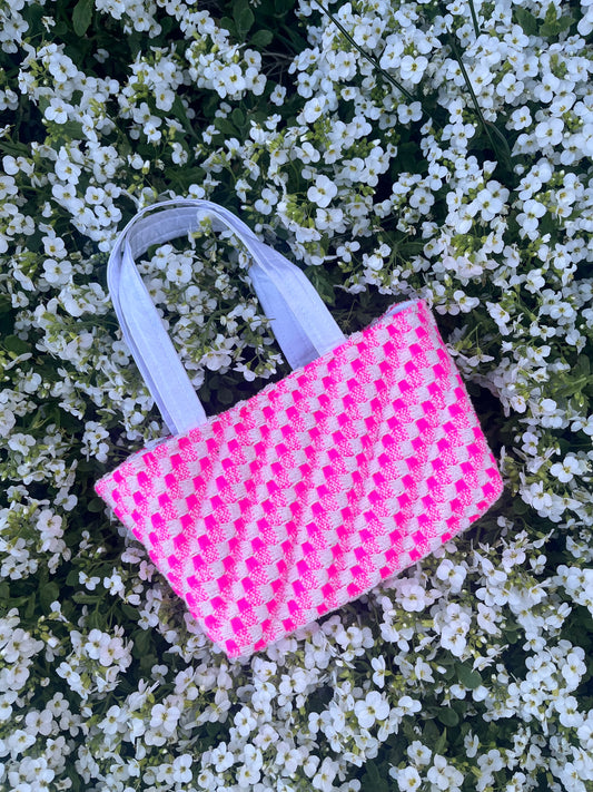 The Warkworth mini handbag crafted from rich tweed, featuring structured satin handles and statement metal hardware for a bold, sophisticated look.