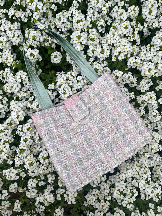 The Corbridge large handbag crafted from heritage tweed, featuring structured satin handles and polished metal hardware for a refined, timeless look.