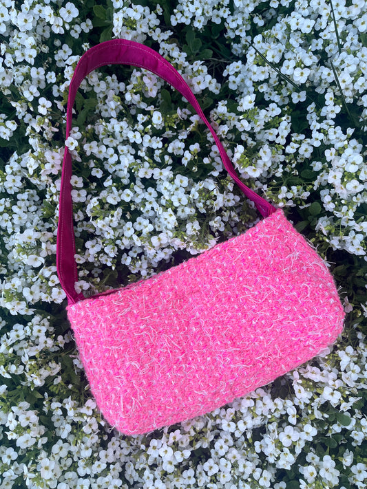 The Howick baguette handbag crafted from sustainable tweed, featuring structured satin handles and elegant metal hardware for a modern heritage look.