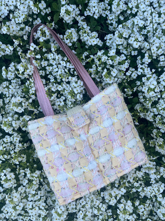 The Ouseburn large-sized tweed handbag, finished with structured satin handles and polished metal hardware for everyday elegance.
