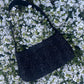 The Cresswell baguette handbag in premium tweed, styled with structured satin handles and polished metal hardware for a chic, compact statement.